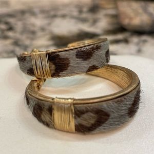 Faux leopard hoop earrings with gold accents.